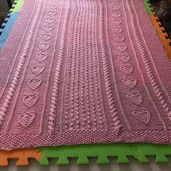 Knitted baby blanket being blocked